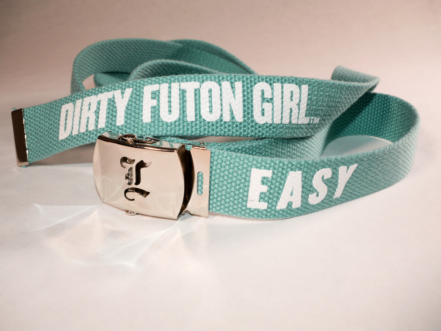 Easy belt. 70 inch long woven web belt with silver buckle and metal tips. Reversible Dirty Futon Girl logo and We Love Sluts screenprint.