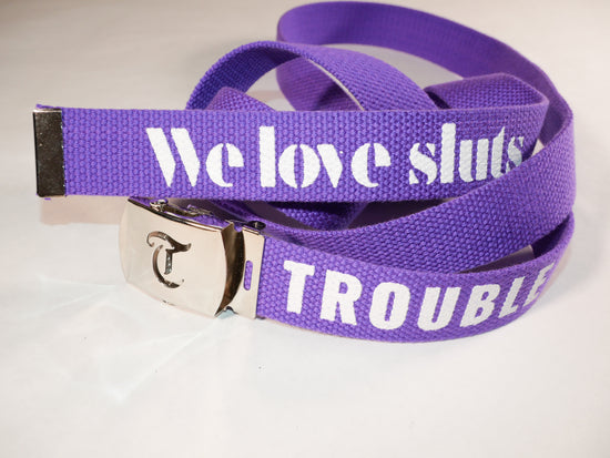 Trouble belt. 70 inch long woven web belt with silver buckle and metal tips. Reversible Dirty Futon Girl logo and We Love Sluts screenprint.